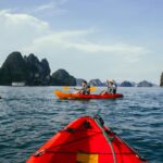 people kayaking on the sea