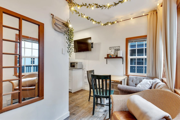 Living room of Grey Whale Studio apartment, with chairs and other seating