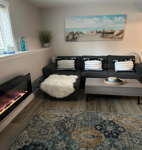 Living room inside a valley vacation suite, focusing on a fireplace and a couch